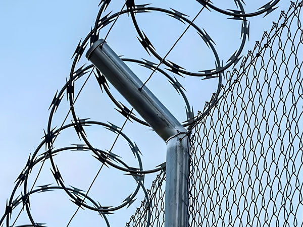 What is the appropriate spacing for installing barbed wire?